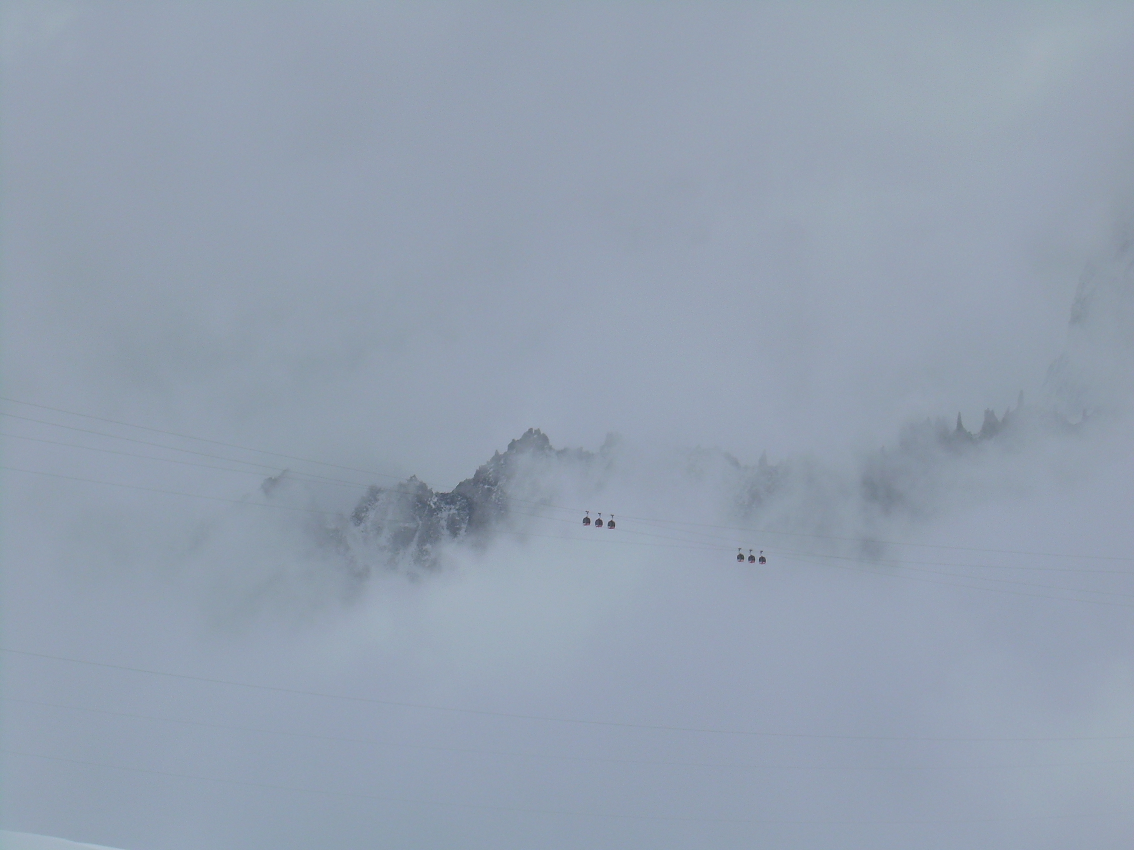 Gondolas against cloudy ridge.JPG